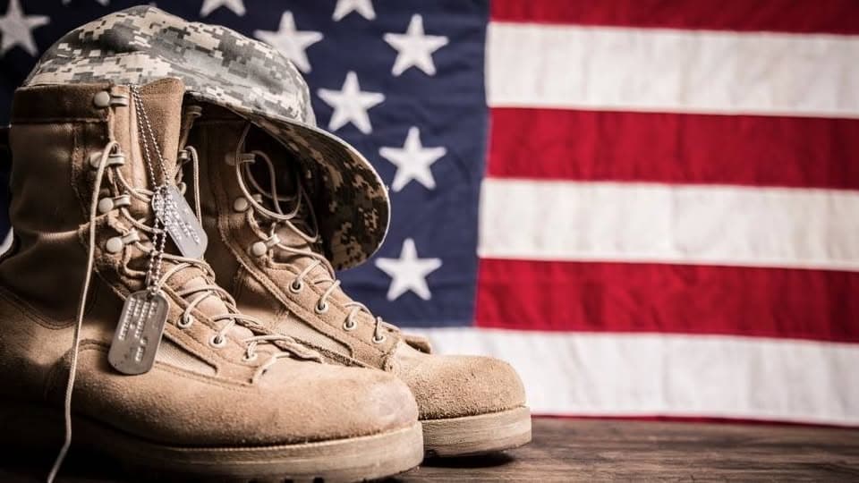 Combat boots, dog tags, and an American flag